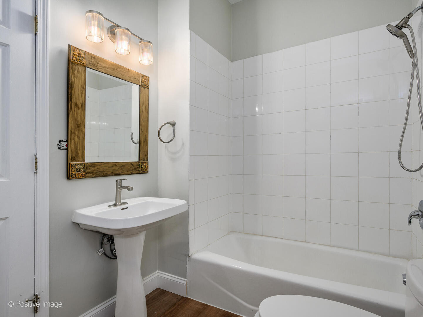 3033 North Racine Avenue, Unit 2 Chicago, IL 60657 - Photo 12 of 20 a bathroom with a sink a mirror a bathtub and shower