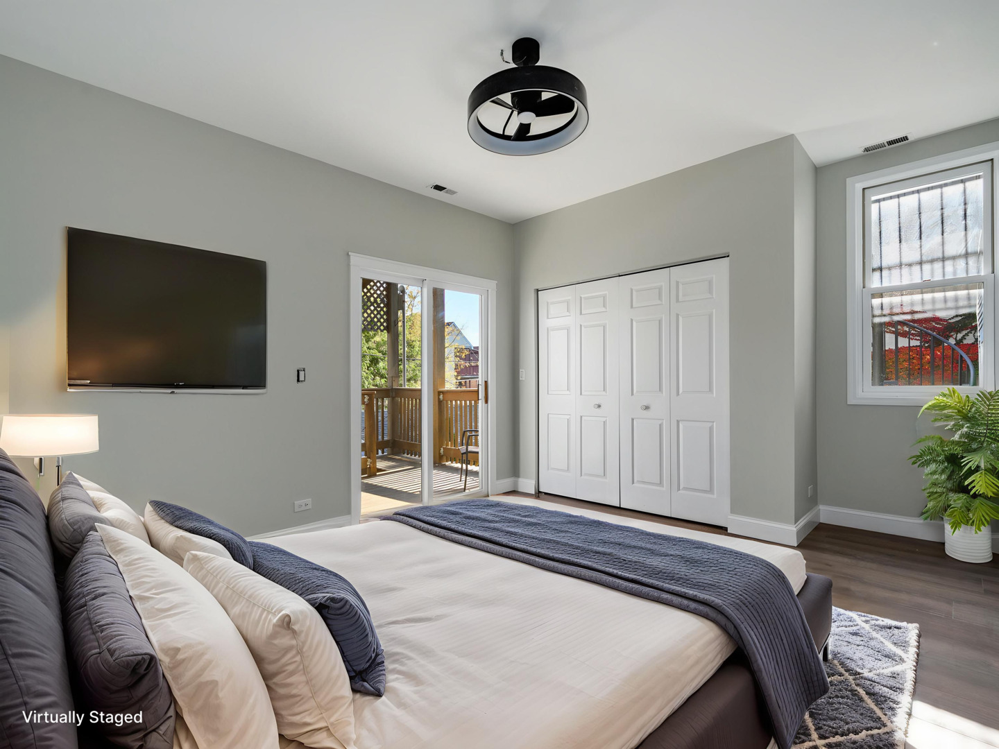 3033 North Racine Avenue, Unit 2 Chicago, IL 60657 - Photo 14 of 20 a bedroom with a bed and a flat screen tv