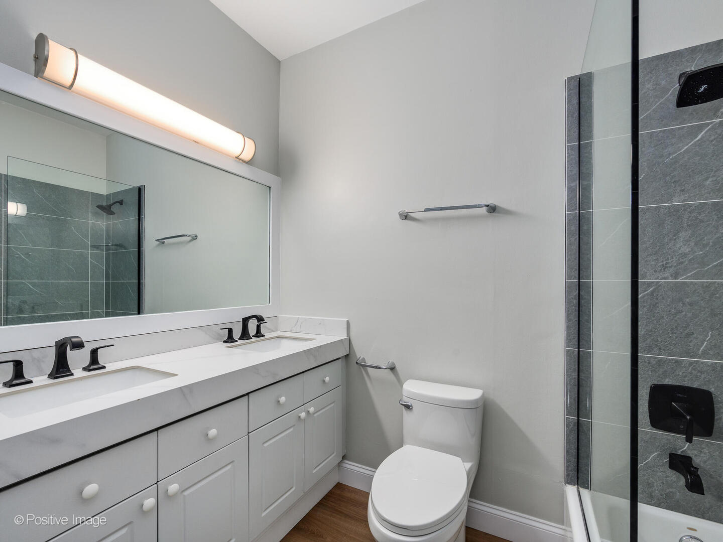 3033 North Racine Avenue, Unit 2 Chicago, IL 60657 - Photo 15 of 20 a bathroom with a double vanity sink toilet and a mirror