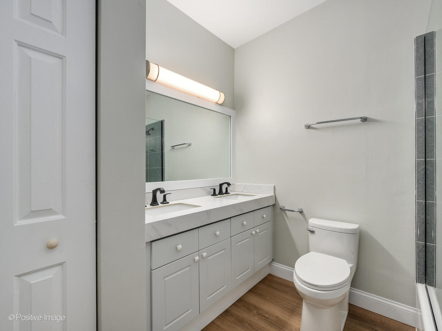 3033 North Racine Avenue, Unit 2 Chicago, IL 60657 - Photo 16 of 20 a bathroom with a toilet sink and mirror