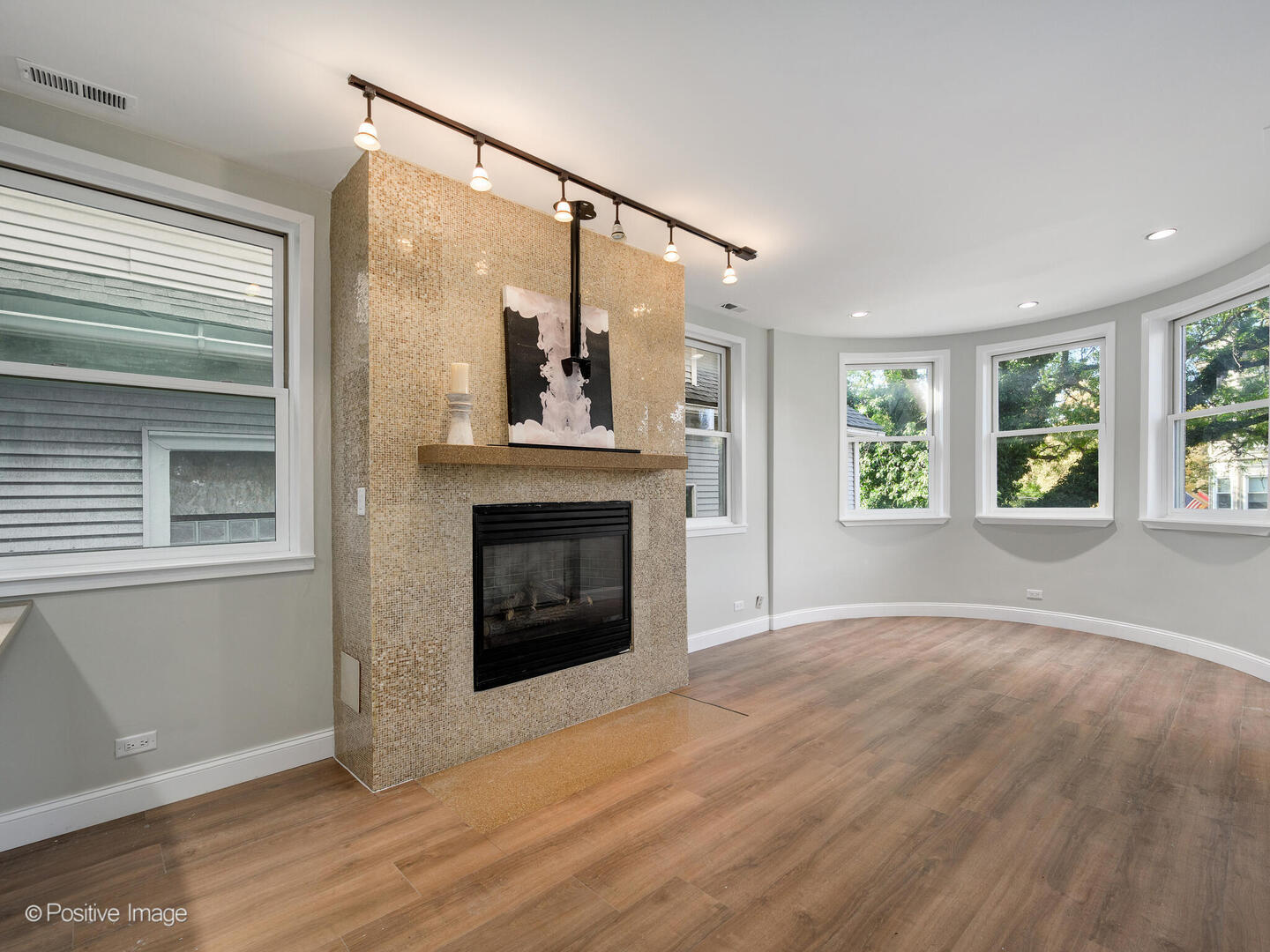 3033 North Racine Avenue, Unit 2 Chicago, IL 60657 - Photo 2 of 20 an empty room with windows and fireplace