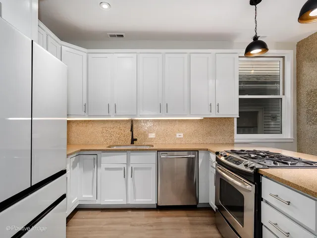a kitchen with a stove and a refrigerator
