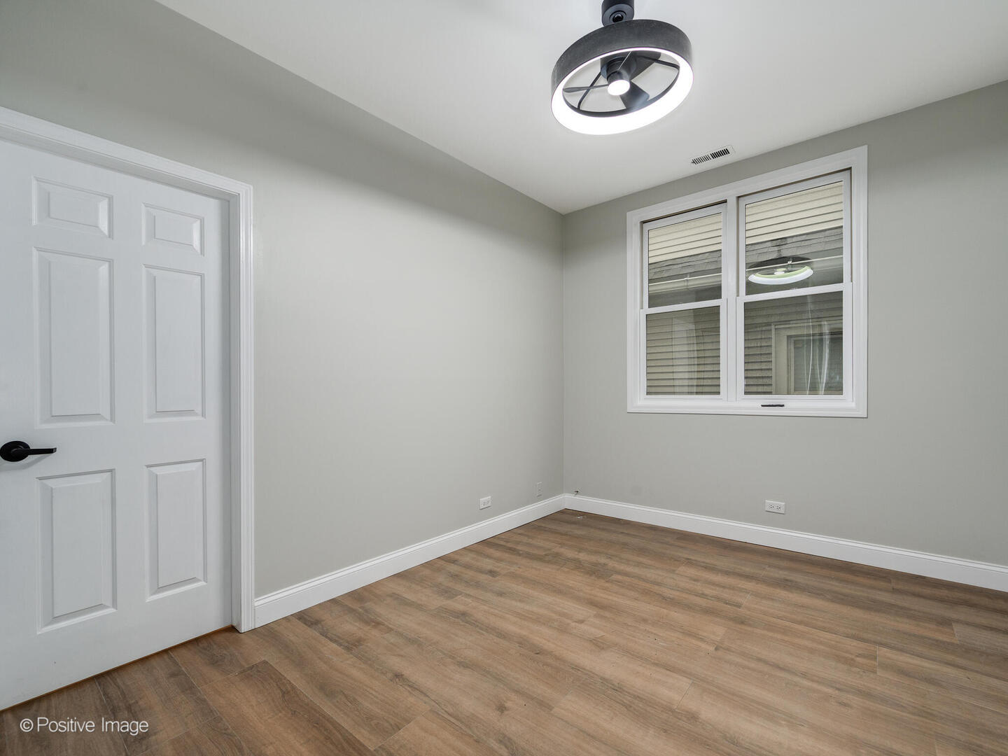 3033 North Racine Avenue, Unit 2 Chicago, IL 60657 - Photo 10 of 20 a view of an empty room with a window and hardwood floor