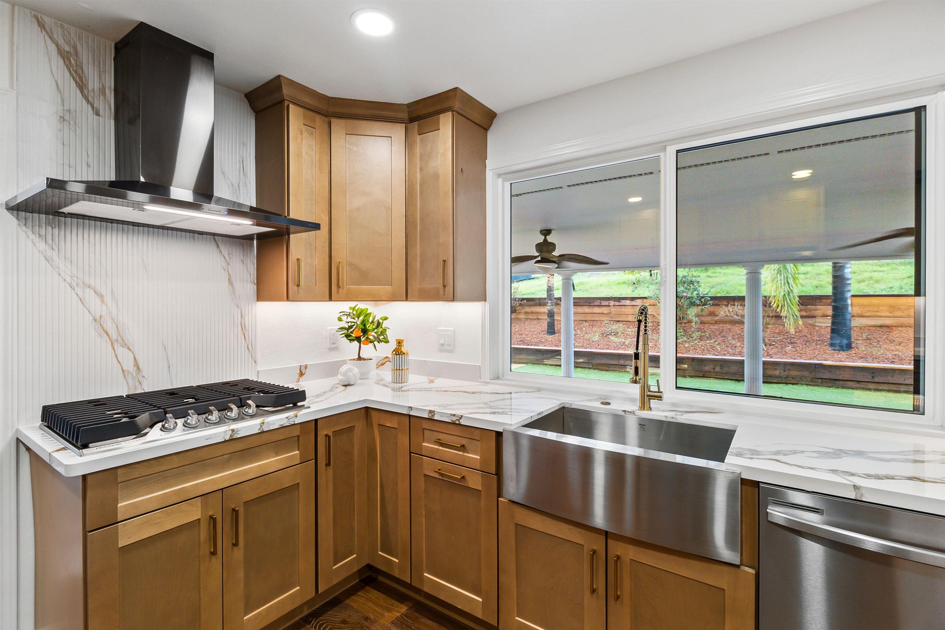 12200 Tesla Road Livermore, CA 94550 - Photo 11 of 60 a kitchen with stainless steel appliances a sink stove and cabinets