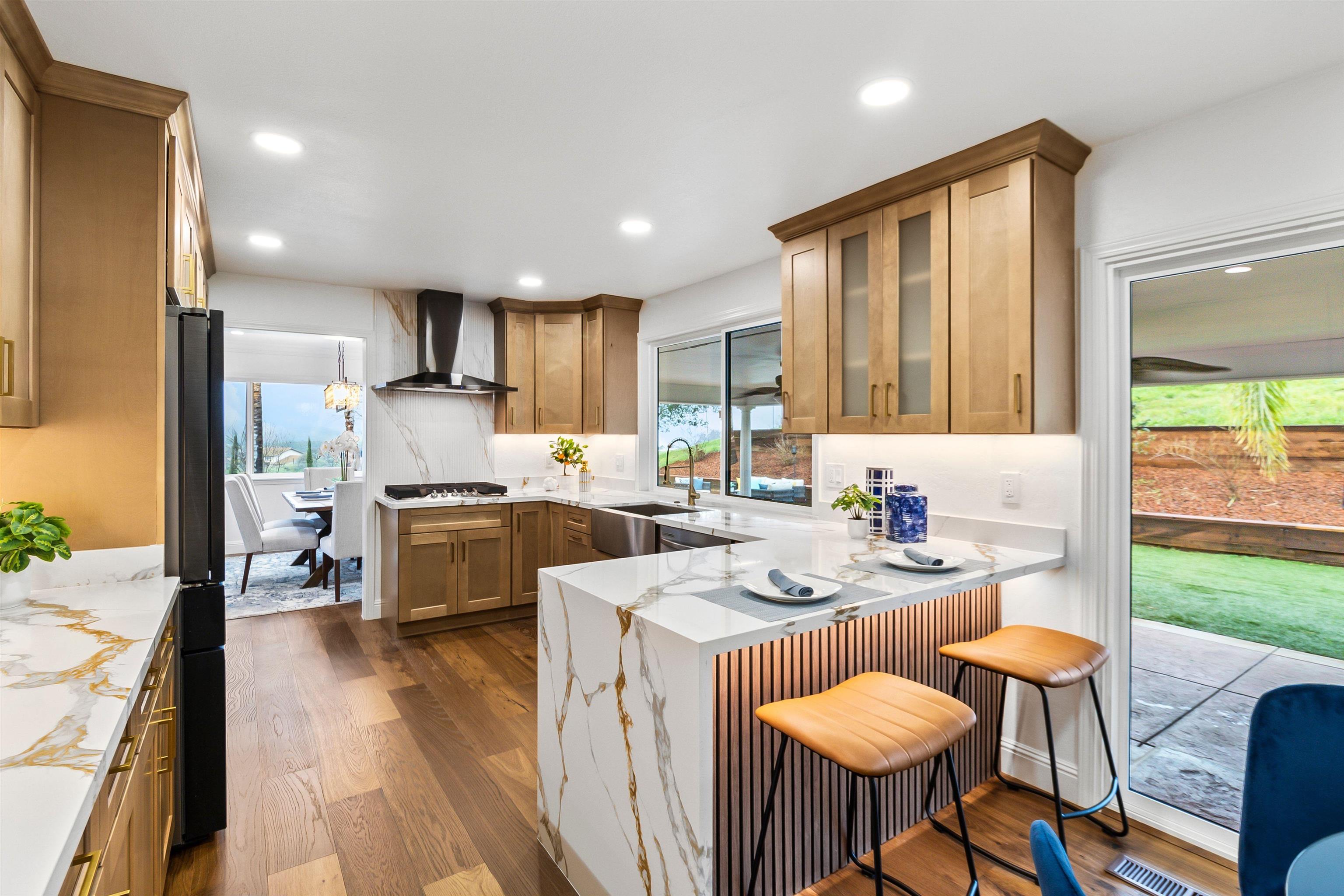 12200 Tesla Road Livermore, CA 94550 - Photo 13 of 60 a kitchen with refrigerator a stove a sink and chairs