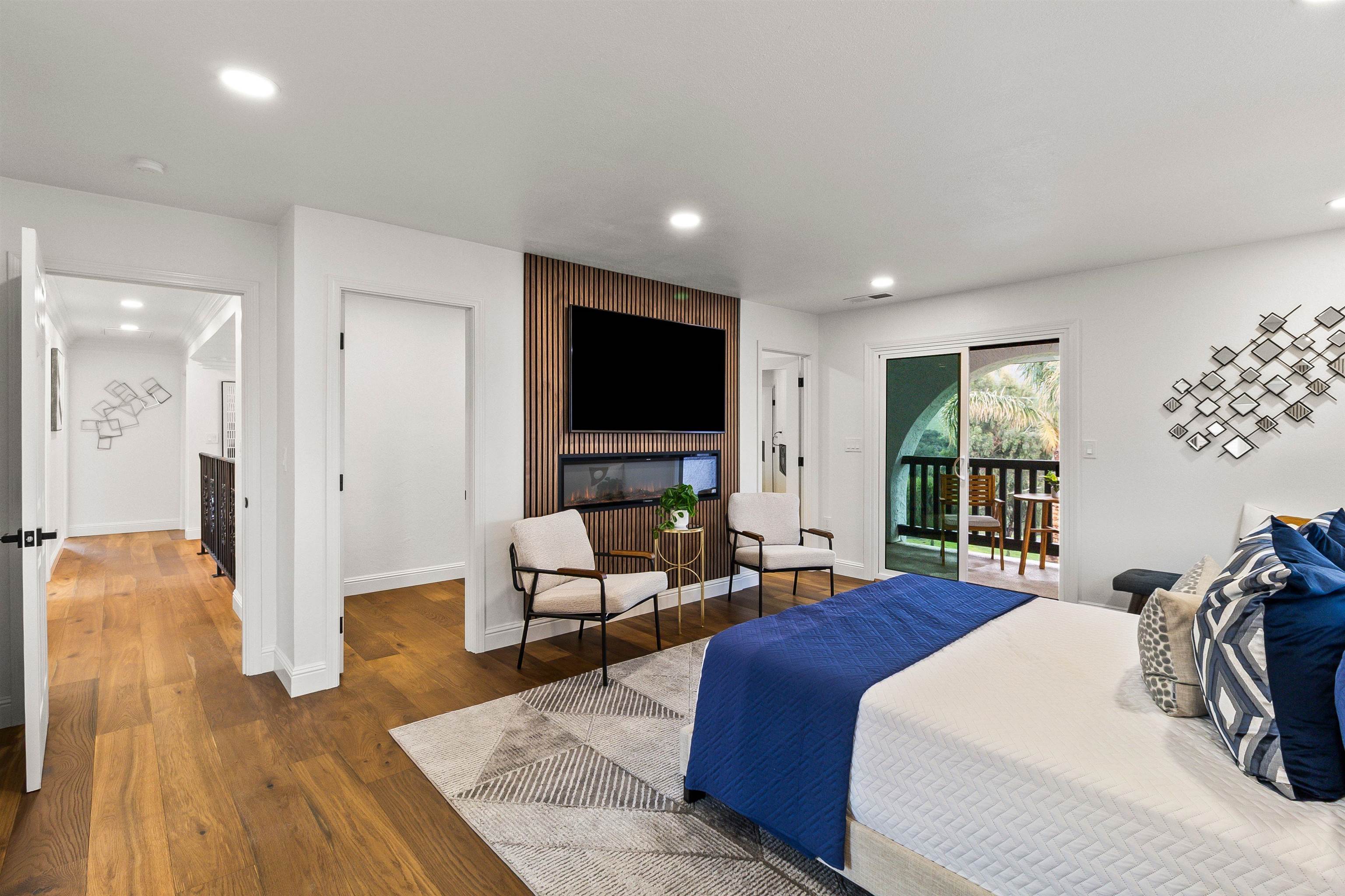 12200 Tesla Road Livermore, CA 94550 - Photo 24 of 60 a spacious bedroom with a bed and a flat screen tv