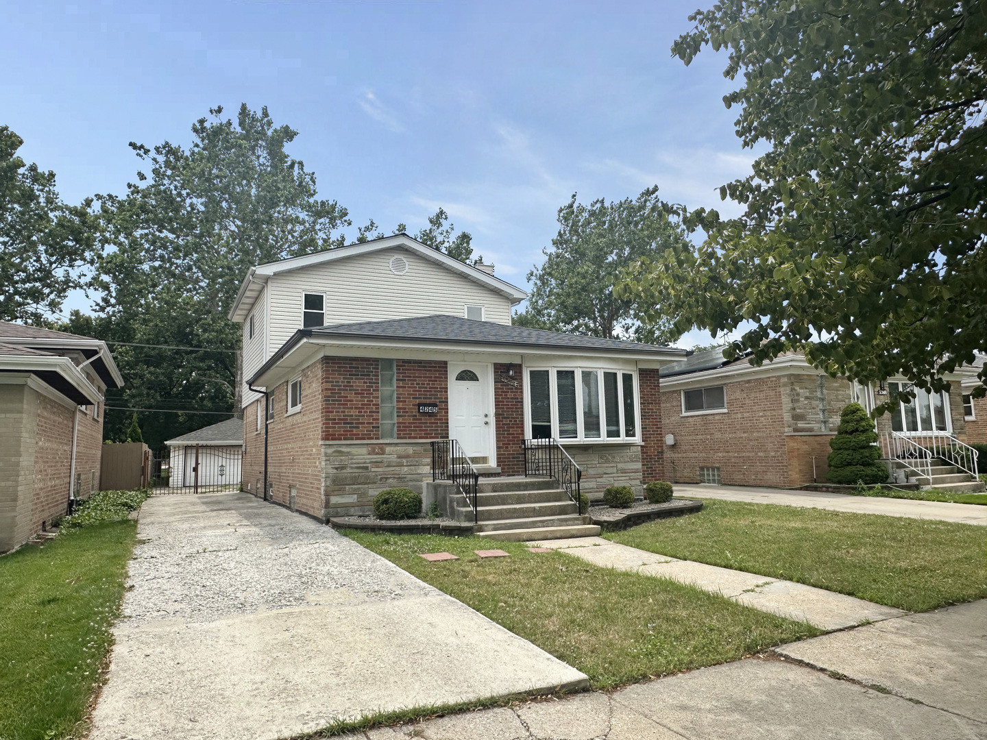 4245 West 78th Street Chicago, IL 60652 - Photo 1 of 21 a front view of a house with a garden