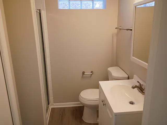 a white toilet sitting next to a bathroom sink