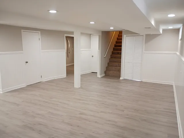 a view of an empty room with stairs and ventilation
