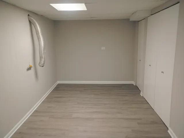 a view of a room with wooden floor