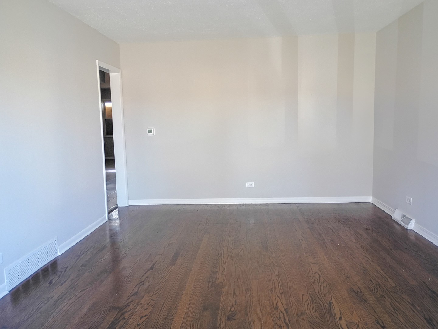 4245 West 78th Street Chicago, IL 60652 - Photo 2 of 21 an empty room with wooden floor and windows