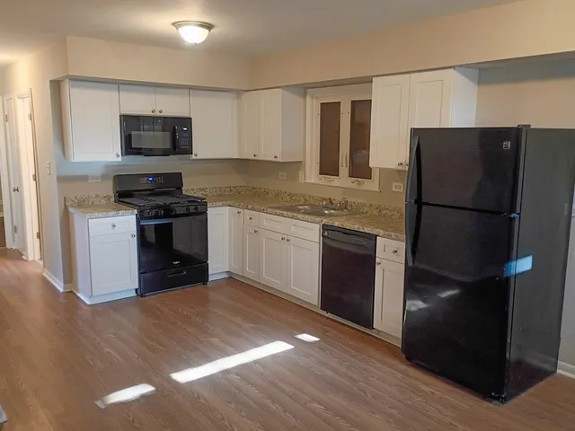 a kitchen with a refrigerator stove and microwave
