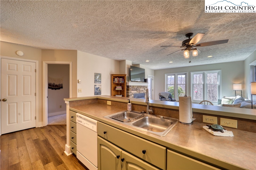 1355 7 Devils Road, Unit 302 Seven Devils, NC 28604 - Photo 12 of 44 a kitchen with a sink and a refrigerator