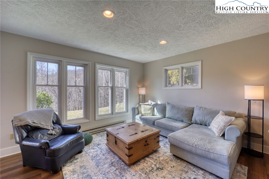 1355 7 Devils Road, Unit 302 Seven Devils, NC 28604 - Photo 8 of 44 a living room with furniture and a large window