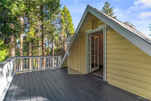 a view of balcony with wooden floor and fence