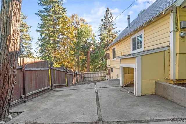 a view of a house with a backyard and garage