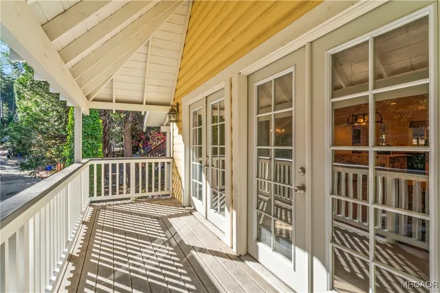 a view of a balcony with wooden floor