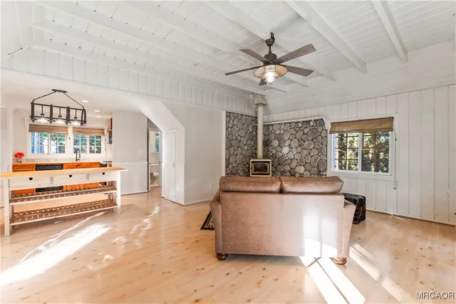 a room with a chandelier and a wooden floor