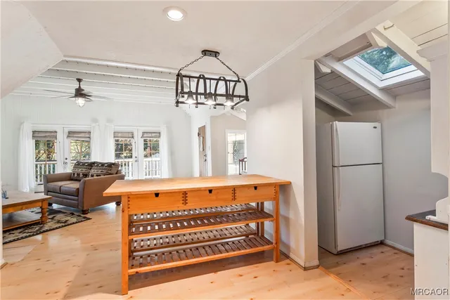 a view of a bedroom with furniture and a window