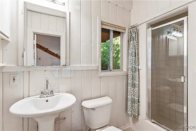 a bathroom with a toilet sink and shower