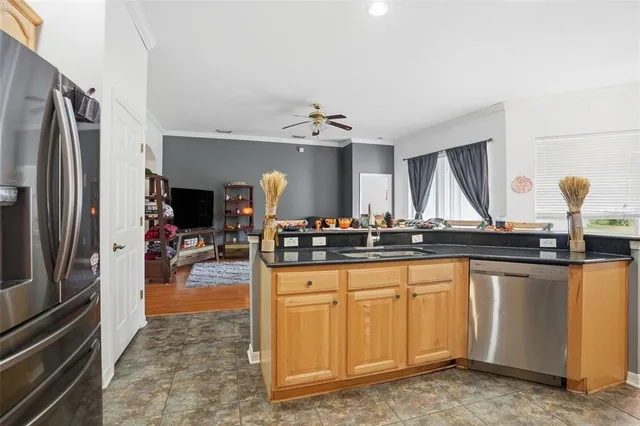 a kitchen with sink cabinets and stainless steel appliances