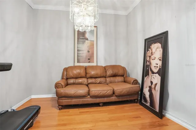 a living room with furniture and a chandelier