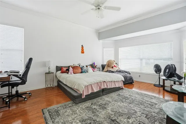a bedroom with two beds and a dresser next to a window