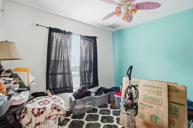 a bedroom with bed and a window