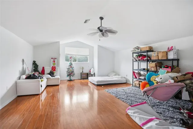 a living room with lots of furniture and a wooden floor