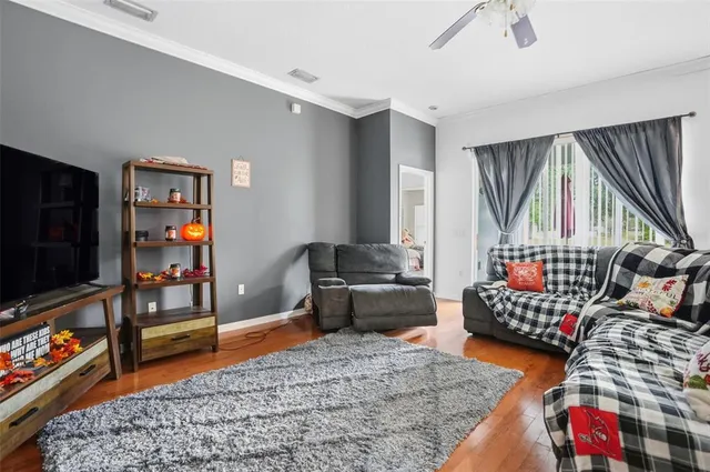 a bedroom with furniture and a flat screen tv