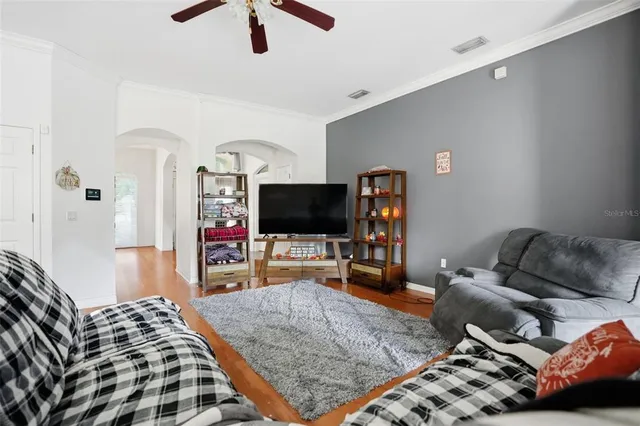 a bedroom with furniture and a flat screen tv