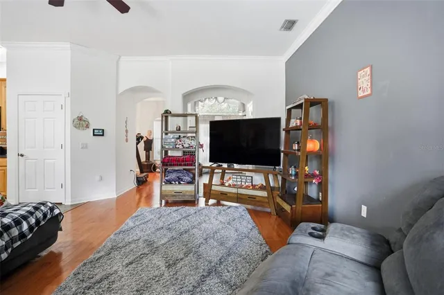 a bedroom with furniture and a flat screen tv