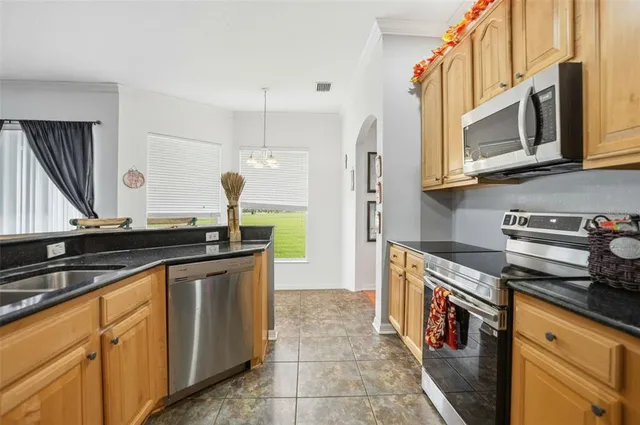 a kitchen with stainless steel appliances granite countertop a sink and a stove