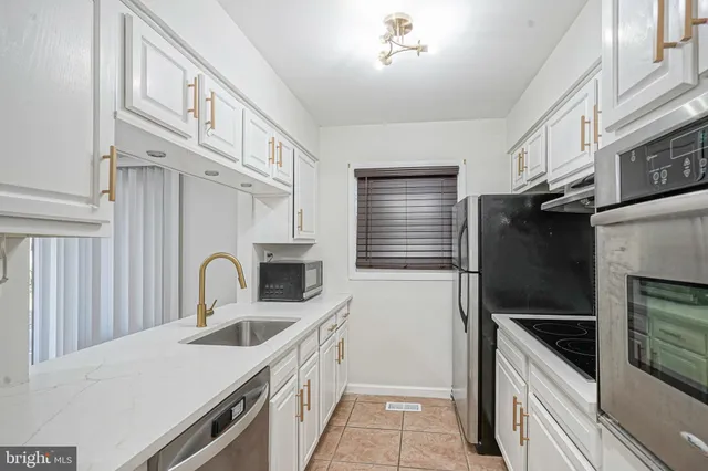 a view of kitchen with refrigerator and window