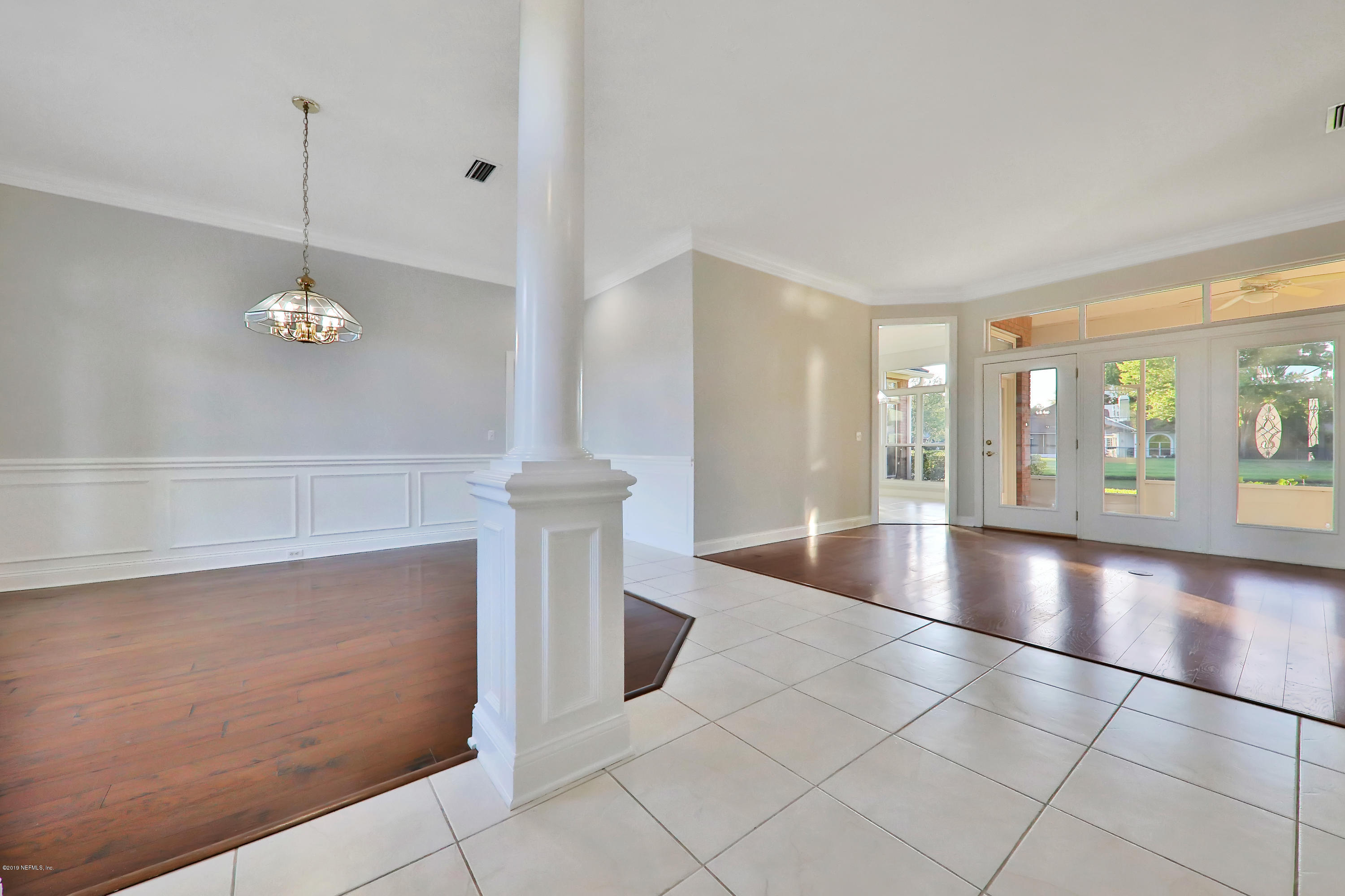 1444 Course View Drive Fleming Island, FL 32003 - Photo 11 of 61 a view of an empty room with chandelier fan and fire place