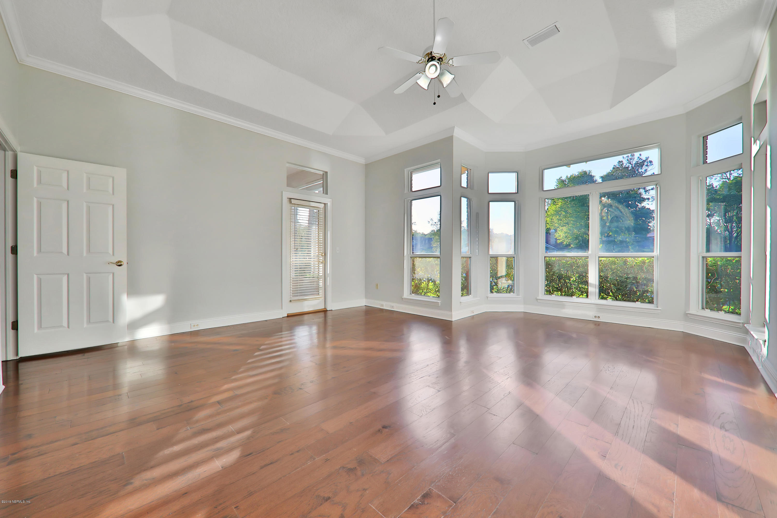 1444 Course View Drive Fleming Island, FL 32003 - Photo 16 of 61 a view of an empty room with wooden floor and a window