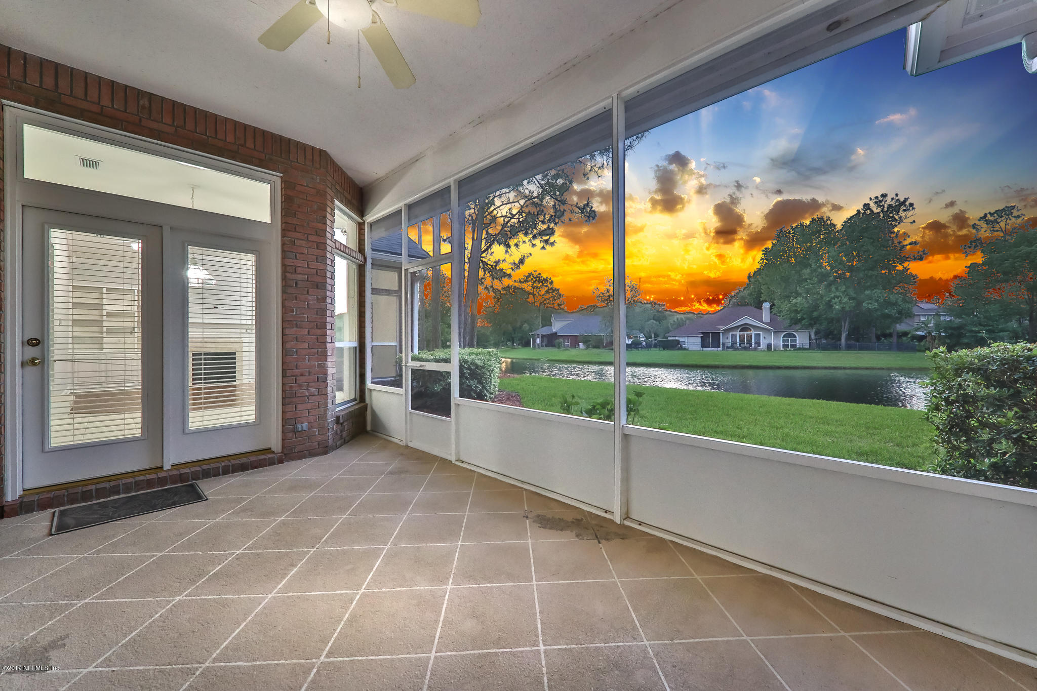 1444 Course View Drive Fleming Island, FL 32003 - Photo 4 of 61 a view of an empty room with a floor to ceiling window and yard