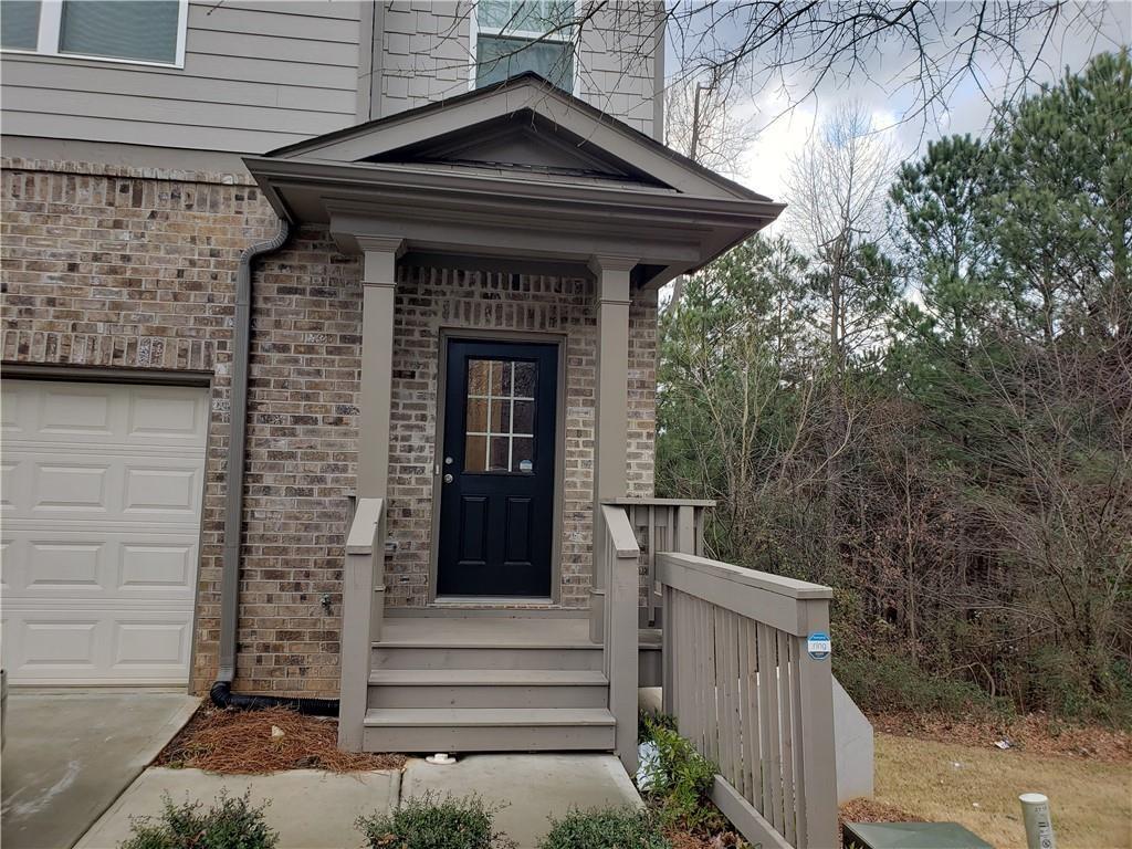 2725 Daybreak Court Suwanee, GA 30024 - Photo 1 of 17 a front view of a house with a garden