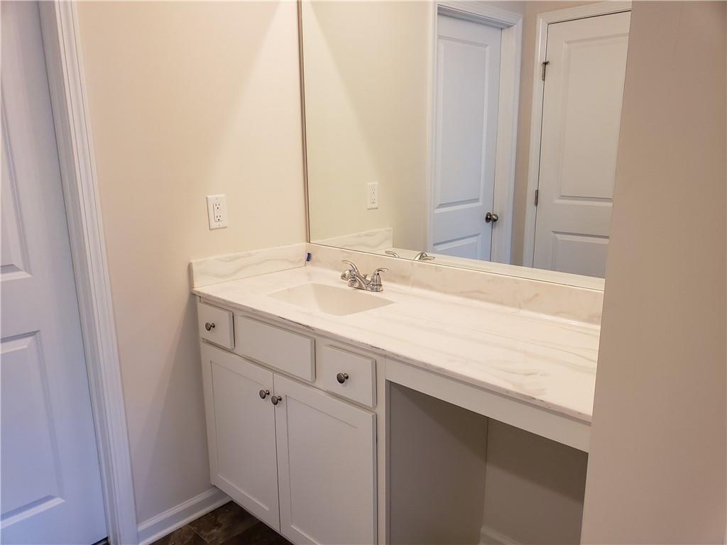 2725 Daybreak Court Suwanee, GA 30024 - Photo 12 of 17 a bathroom with a sink vanity and a mirror
