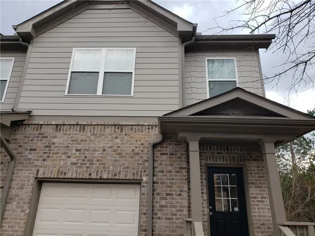 a front view of a house with garage