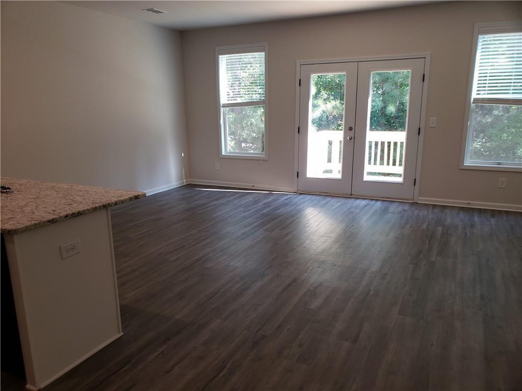 2725 Daybreak Court Suwanee, GA 30024 - Photo 3 of 17 a view of an empty room with wooden floor and a window