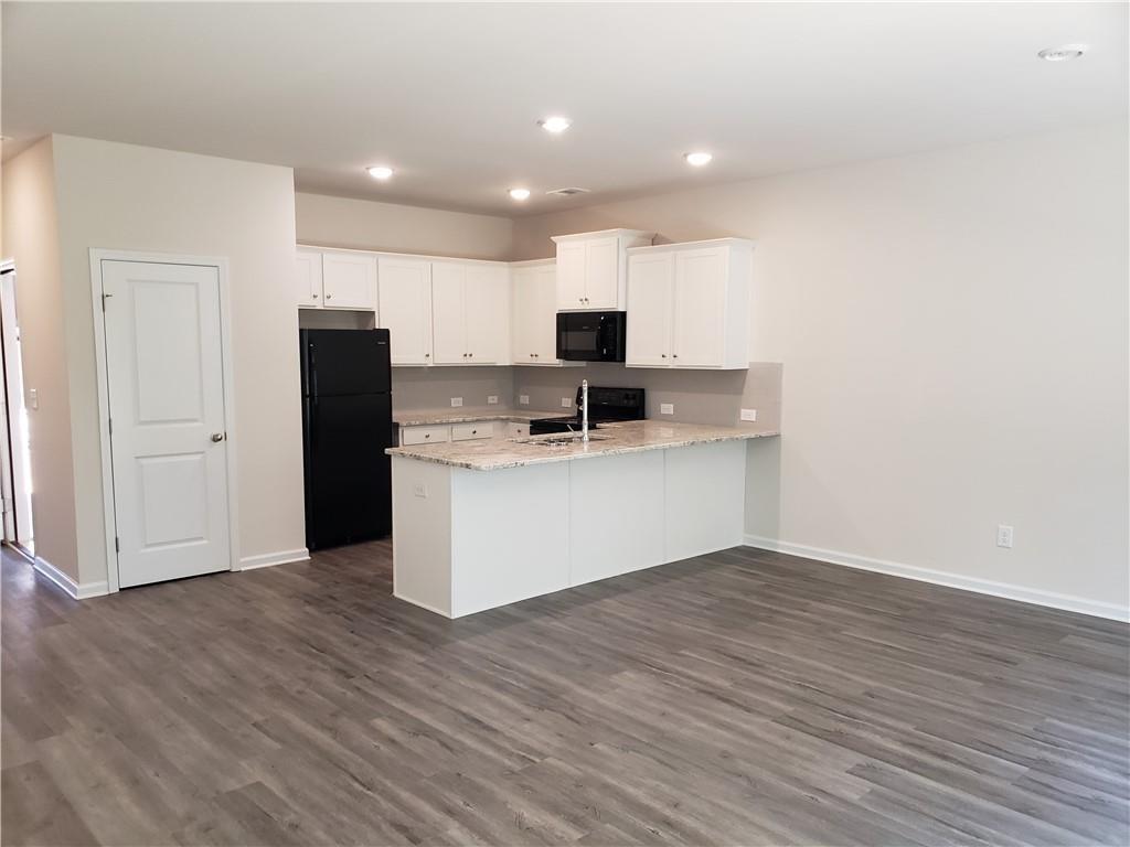 2725 Daybreak Court Suwanee, GA 30024 - Photo 4 of 17 a view of kitchen with granite countertop cabinets and refrigerator