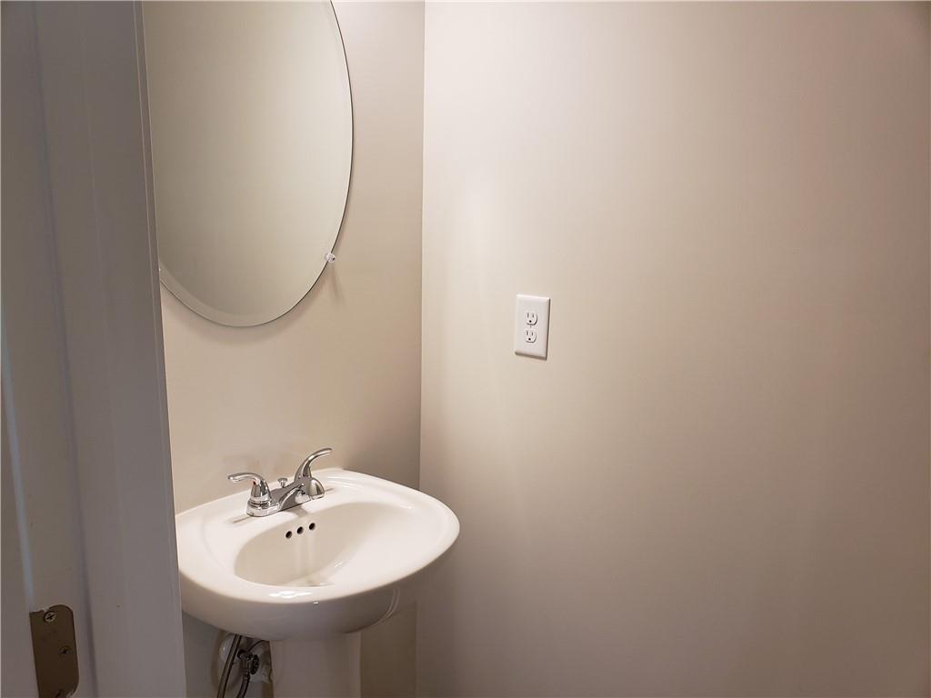 2725 Daybreak Court Suwanee, GA 30024 - Photo 7 of 17 a bathroom with a sink and a mirror