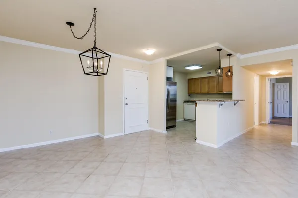 a view of a kitchen with a sink and a chandelier