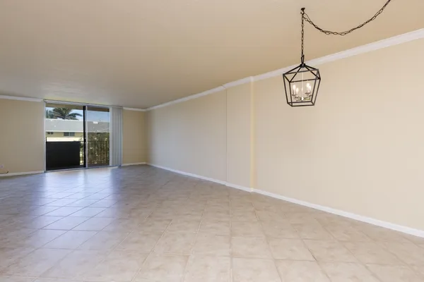 a view of empty room with wooden floor and stove