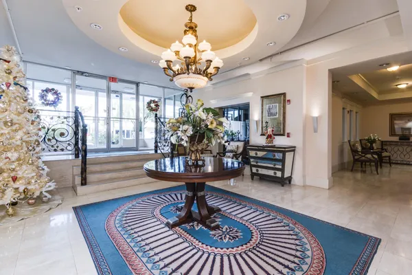 a living room with furniture and a chandelier