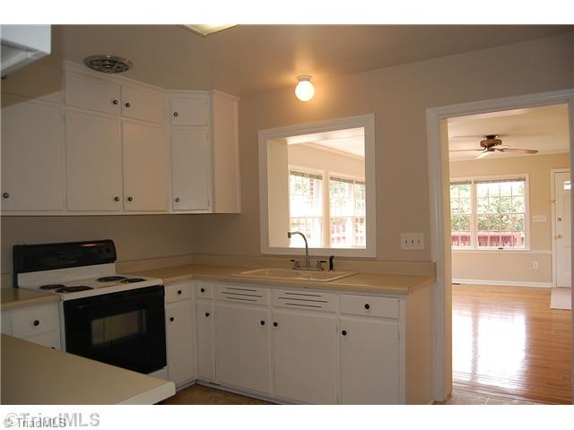 401 Lindley Road Greensboro, NC 27410 - Photo 3 of 16 Kitchen. The cheerful kitchen features cabinet storage reaching to the ceiling. The kitchen is centrally located between the formal living and dining room on one side, and the family room on the other. Serving a meal or grabbing a snack is only a few steps away.