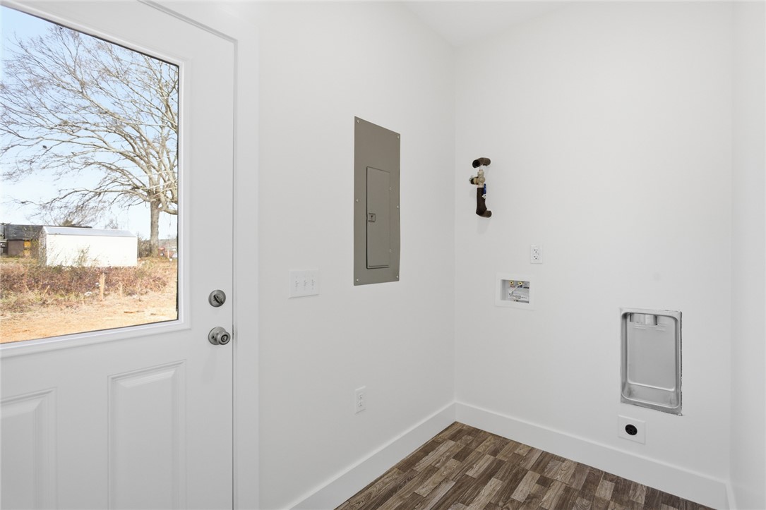 115 Riley Street Westminster, SC 29693 - Photo 22 of 46 This dedicated laundry area features durable flooring and essential utility connections.