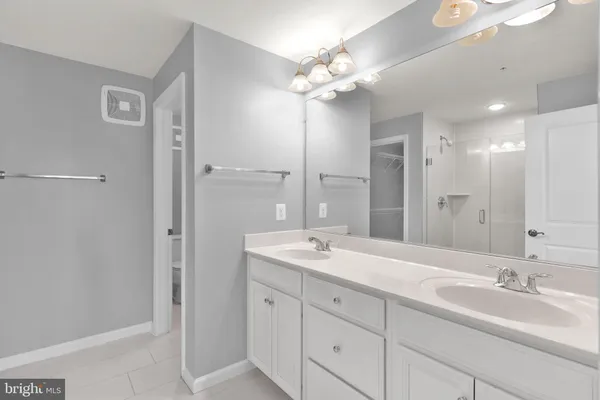 a bathroom with a double vanity sink mirror and double
