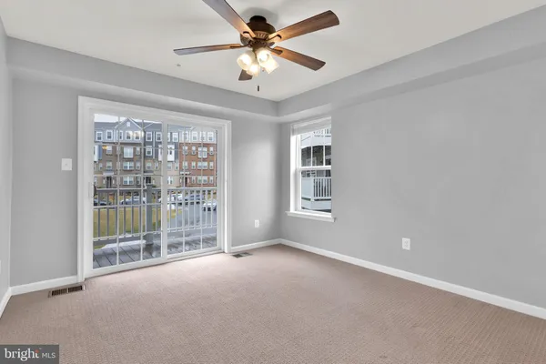a view of a livingroom with a ceiling fan and window